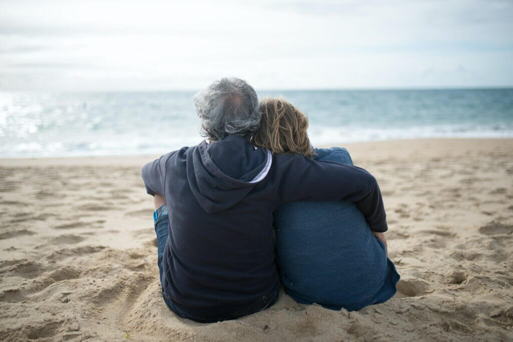 old couple relaxing on the beach parkinson's case study