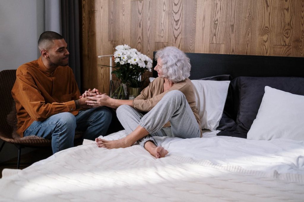 man holding hands with a woman suffering from Alzheimer's Disease